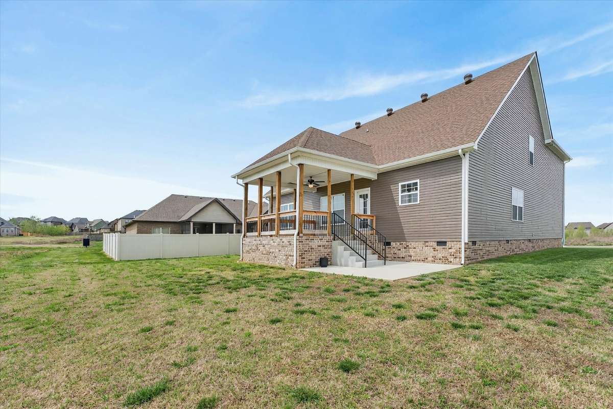 Side view of home showcasing large yard and exterior space