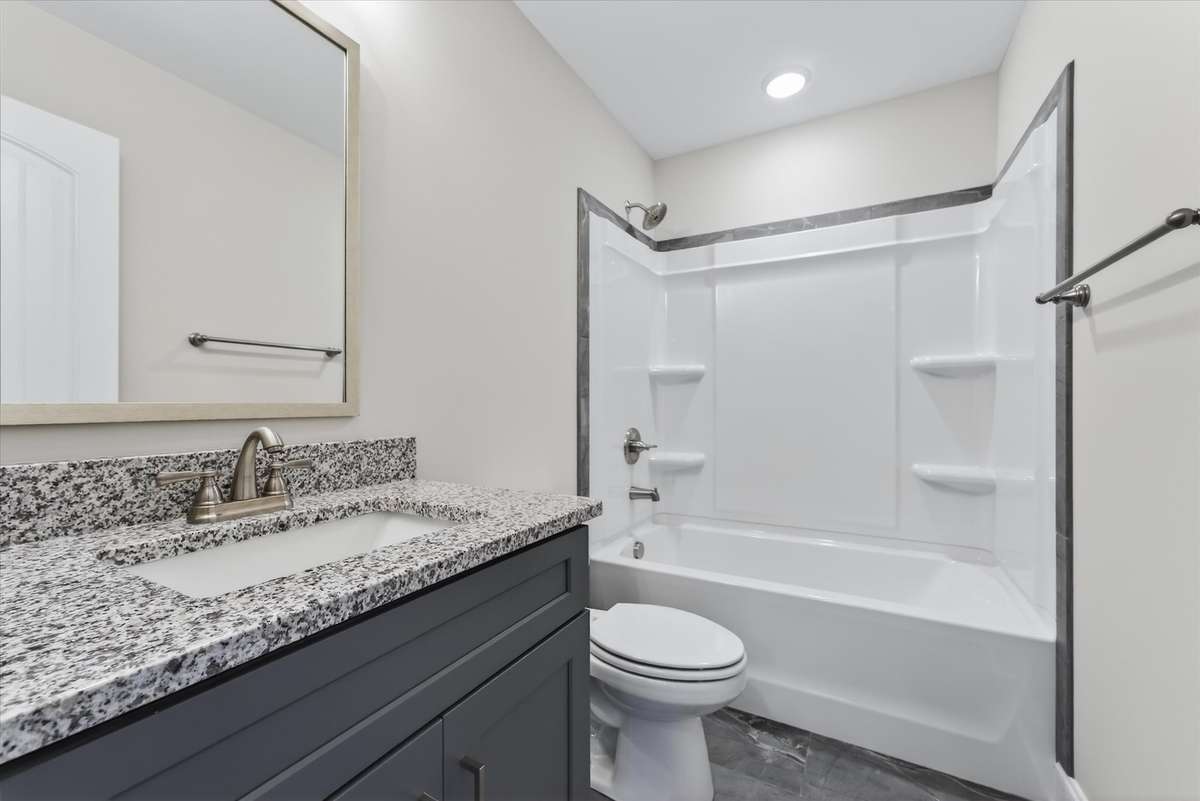 Bathroom vanity with granite countertops and modern cabinetry