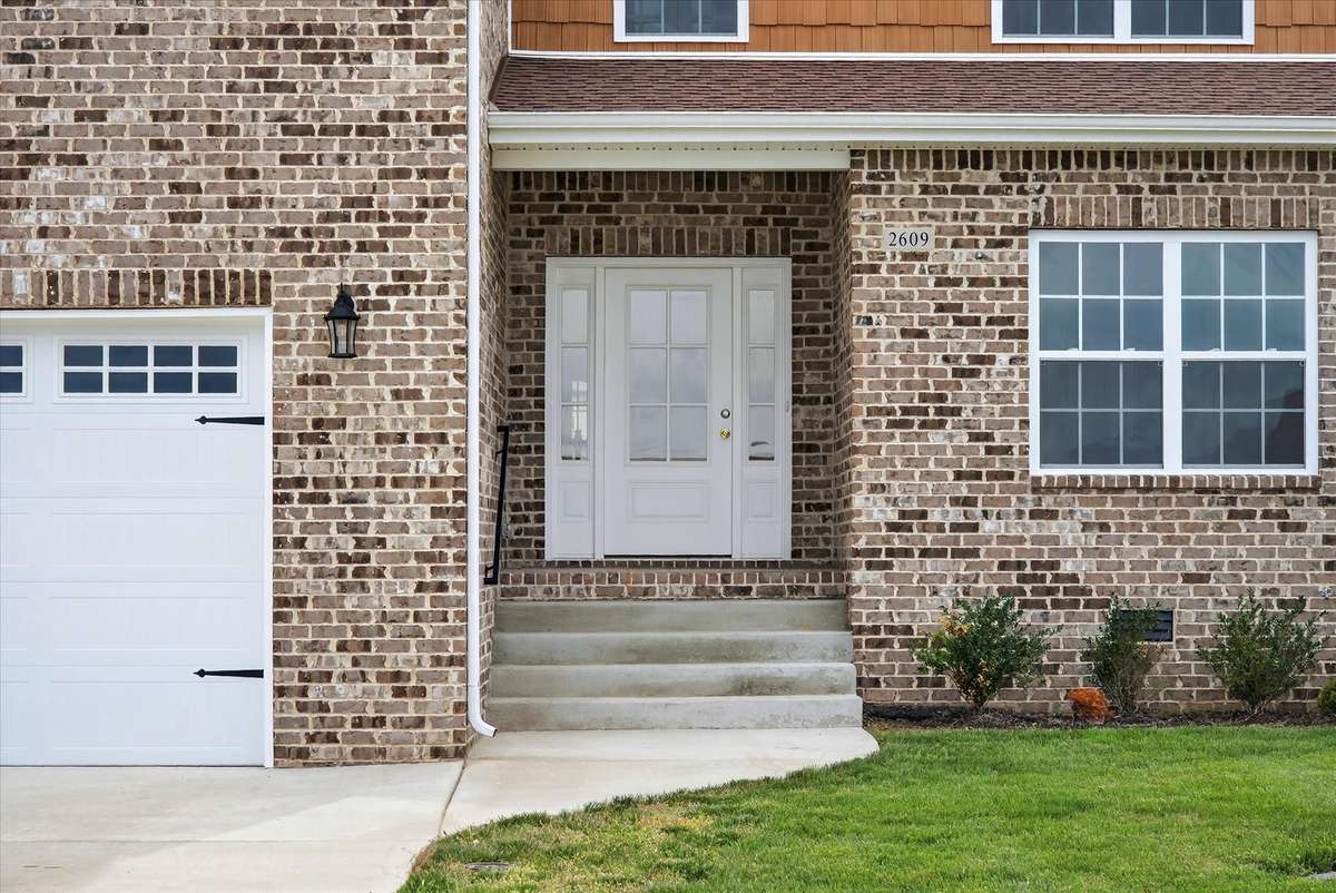 Inviting front entry with brick detail and covered porch