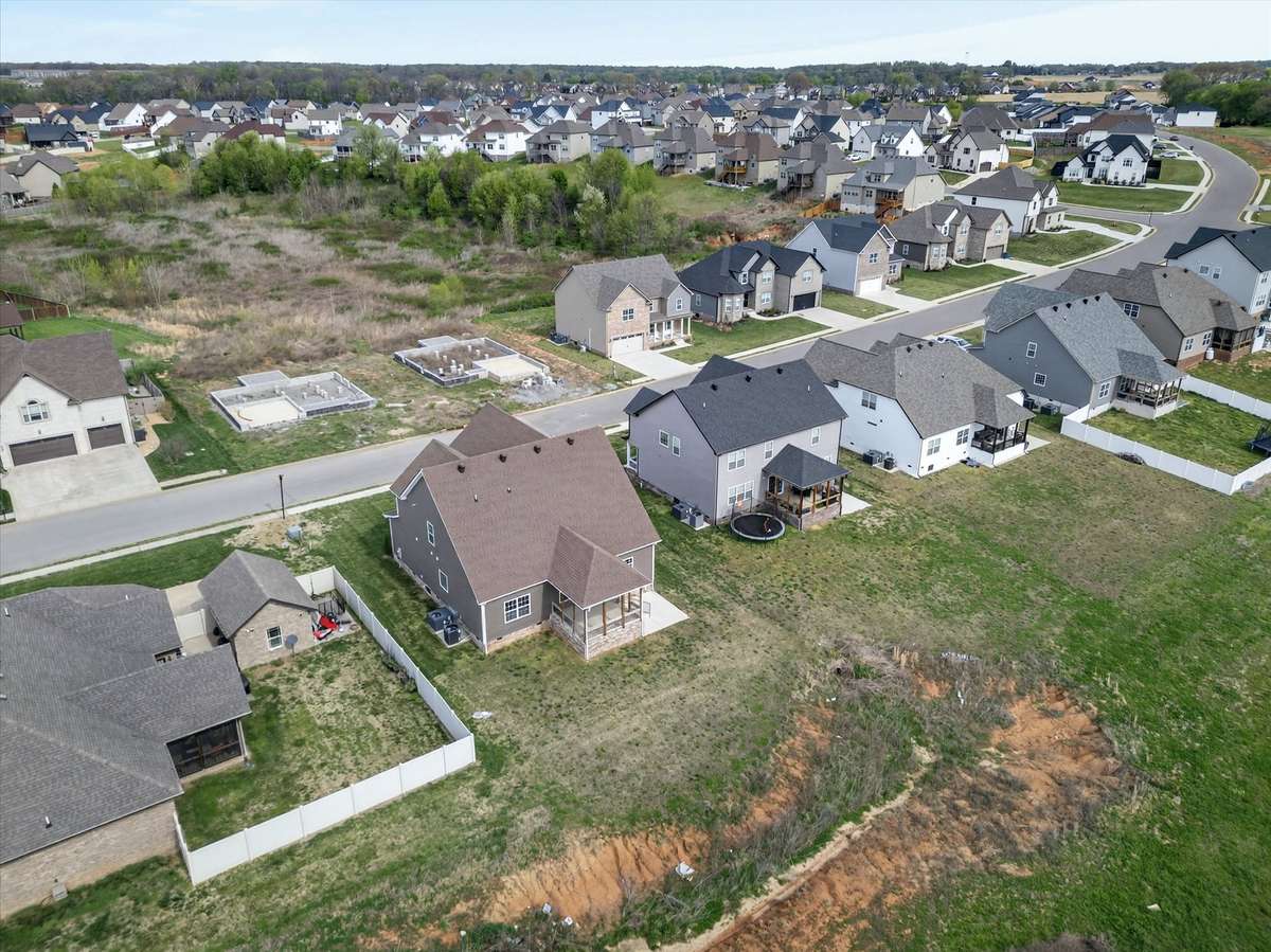 Aerial perspective of home within established community.
