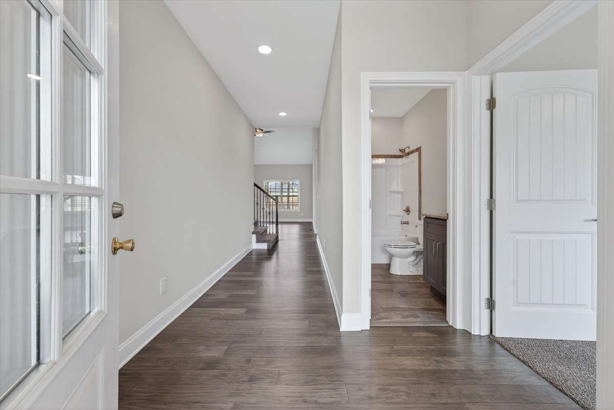 Bright entry hallway with modern flooring and open flow.