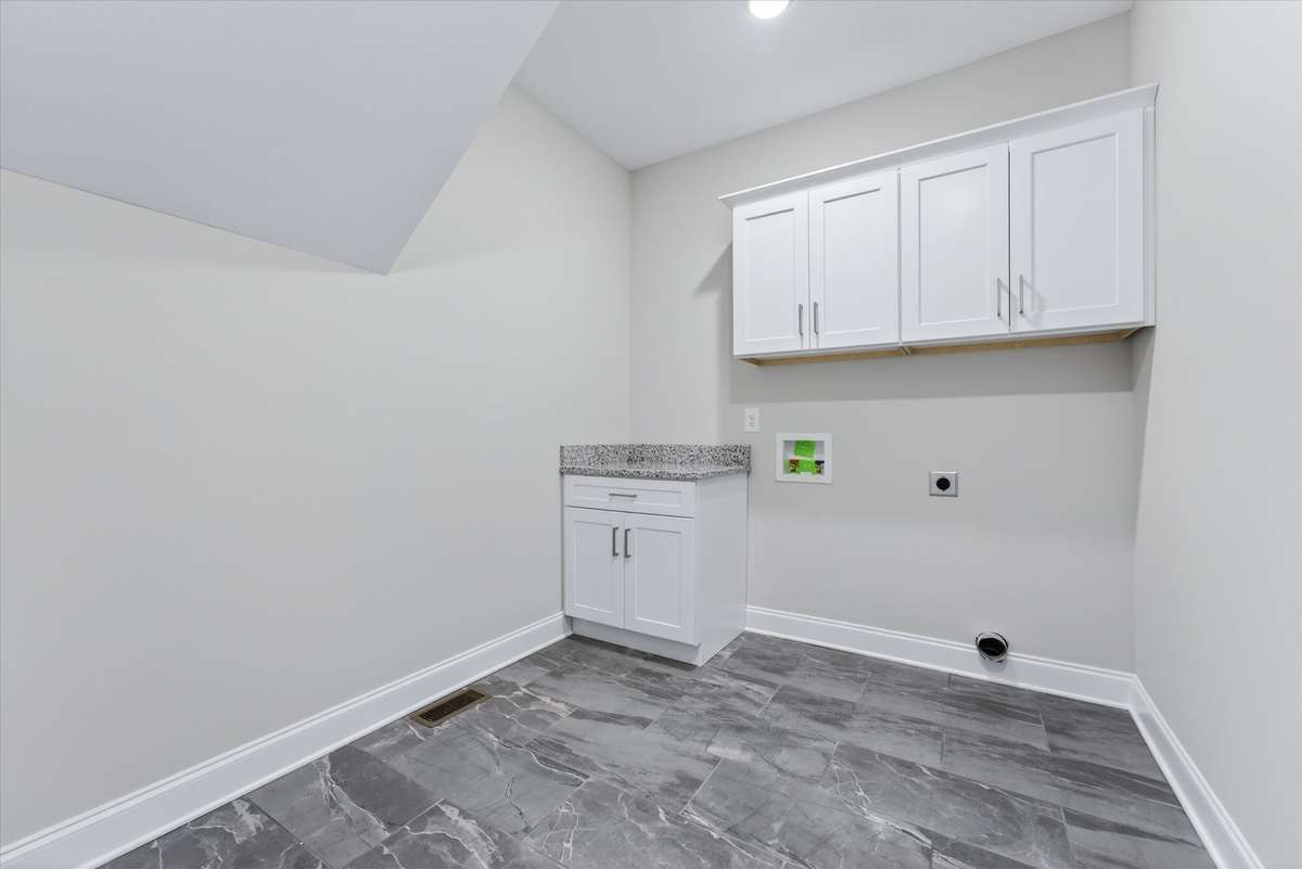 Dedicated laundry room with cabinetry and workspace