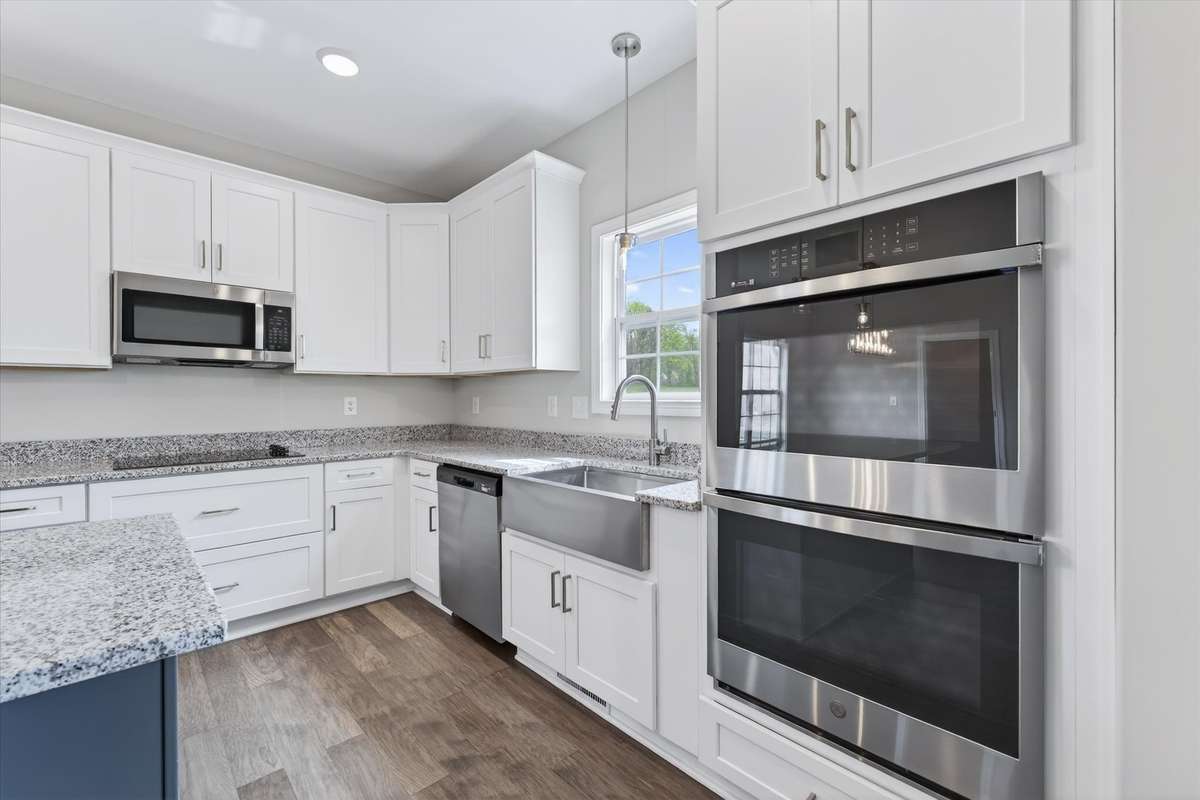 Modern kitchen with stainless appliances, double oven, and ample cabinetry.