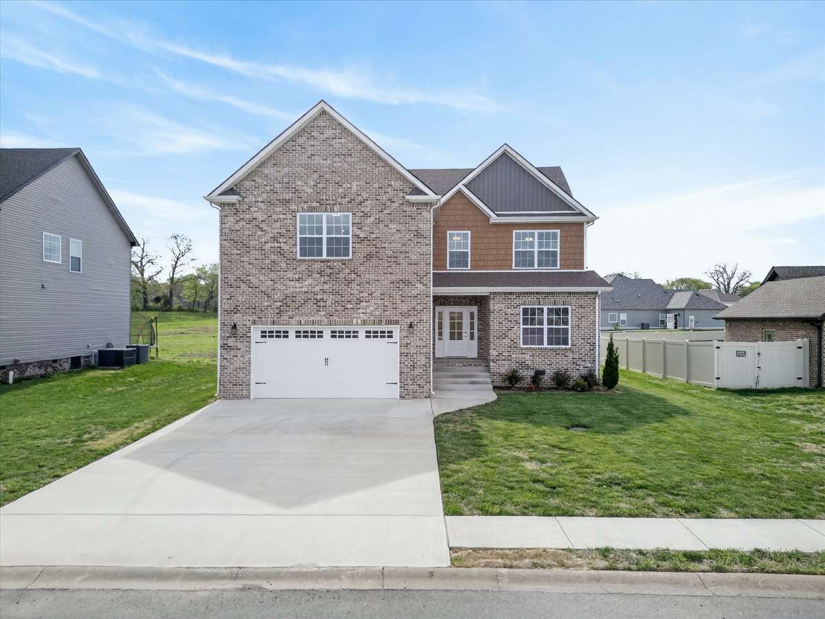 Spacious driveway and well-maintained exterior in a sidewalk-lined neighborhood