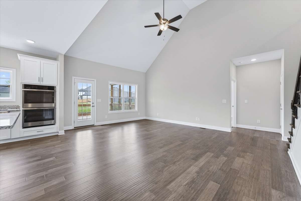 Open-concept living room with vaulted ceilings and abundant natural light