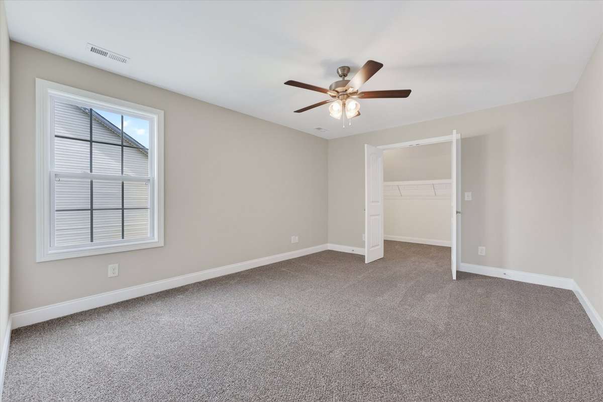 Comfortable bedroom with neutral tones and functional layout.