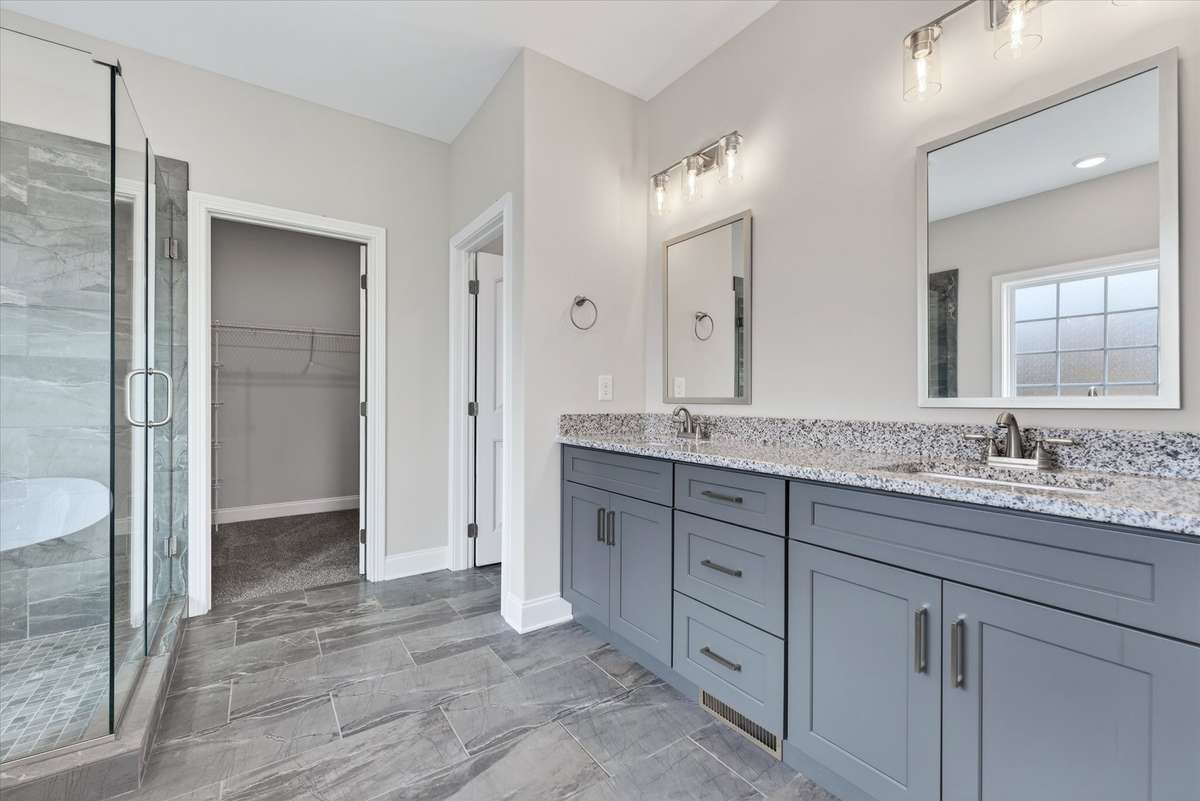 Primary bath with walk-in shower, dual access, and spacious layout.