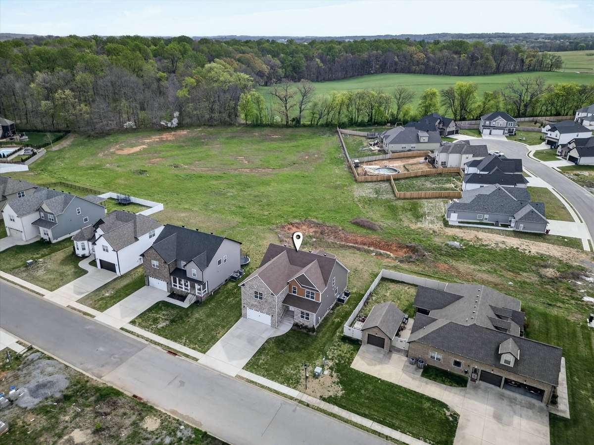 Aerial view featuring nearby green space and neighborhood setting
