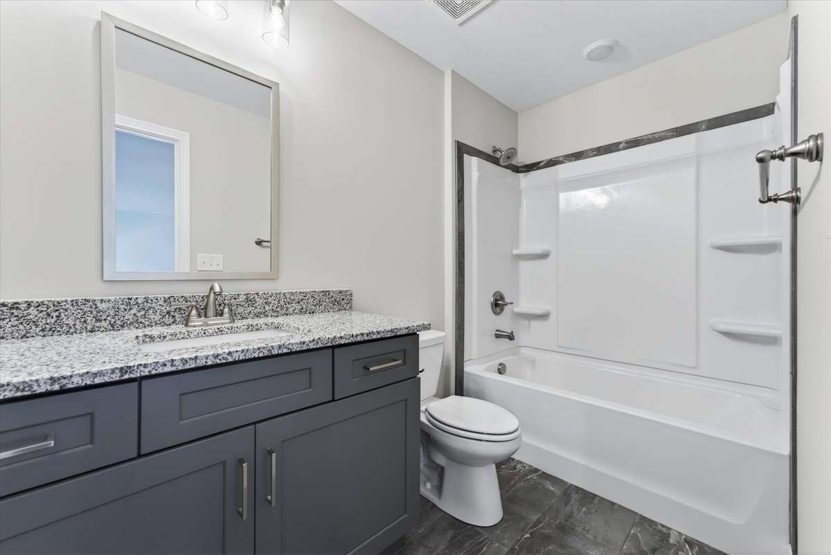 Full bathroom with clean finishes and ample space.