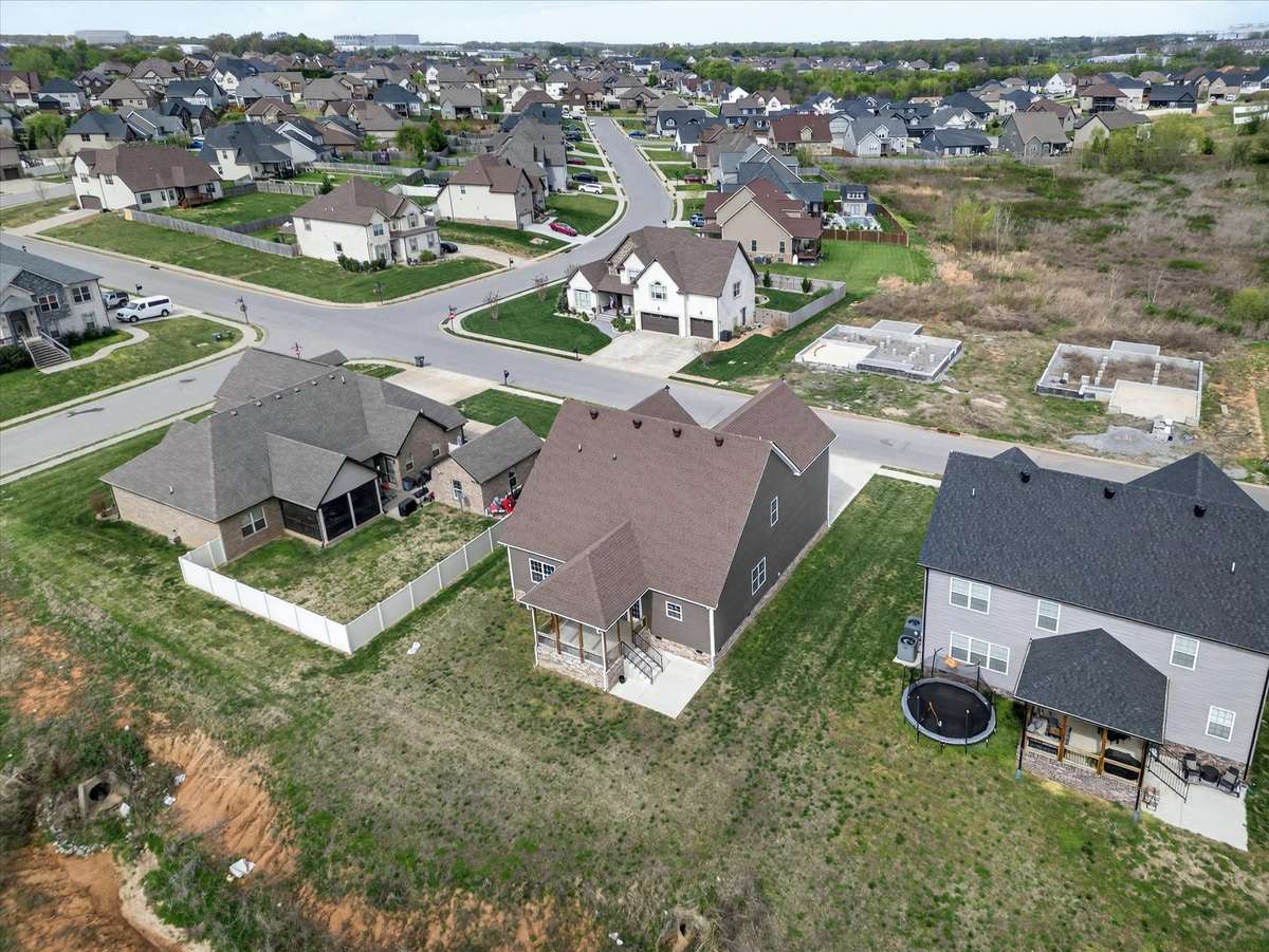 Aerial view capturing backyard and surrounding lots.