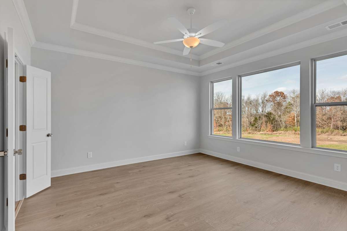 The primary bedroom is on main floor with this beautiful large bay window for lots of natural light