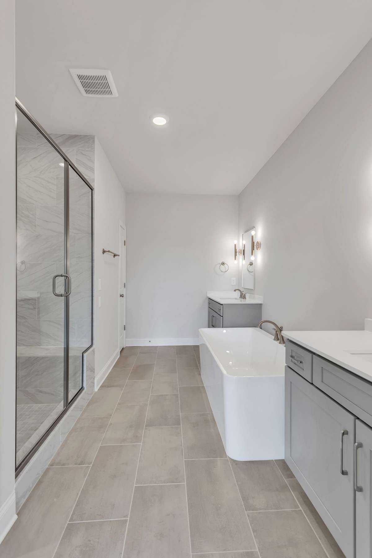 The primary bathroom has both a shower with a bench and a freestanding tub and seperate sinks