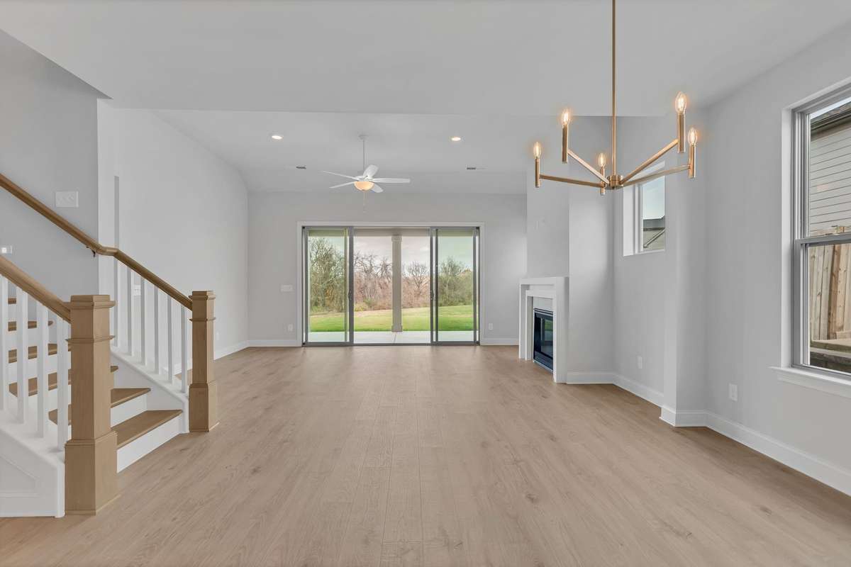 Slider doors offers views of the open green space and tree lined back yard