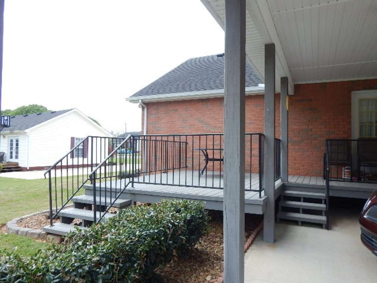 Portion of deck is covered and accessible from dining room and utility room
