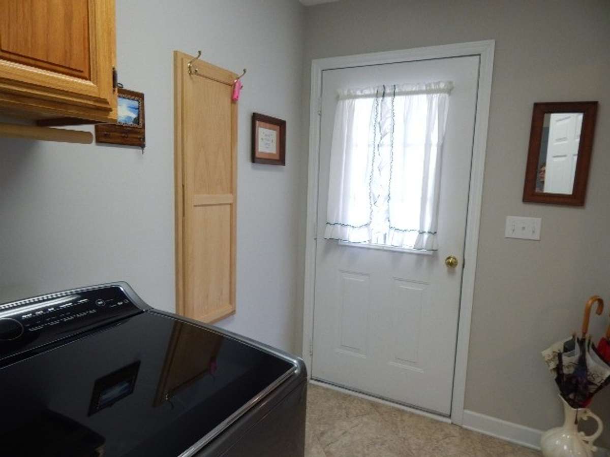 Utility room with door to back covered deck.