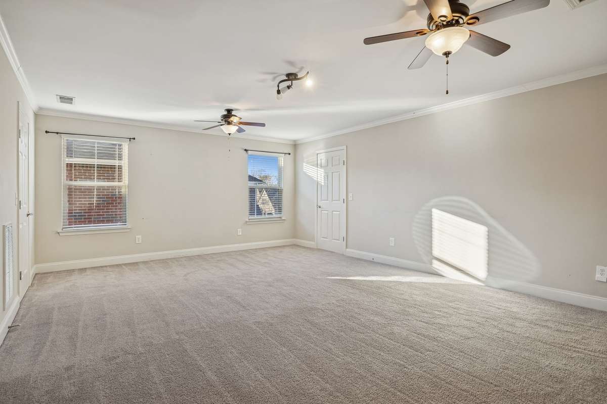 UPSTAIRS: Large bonus room ideal for media, recreation, or additional living space.
The doors to the left and right are walk-in attic storage with lights