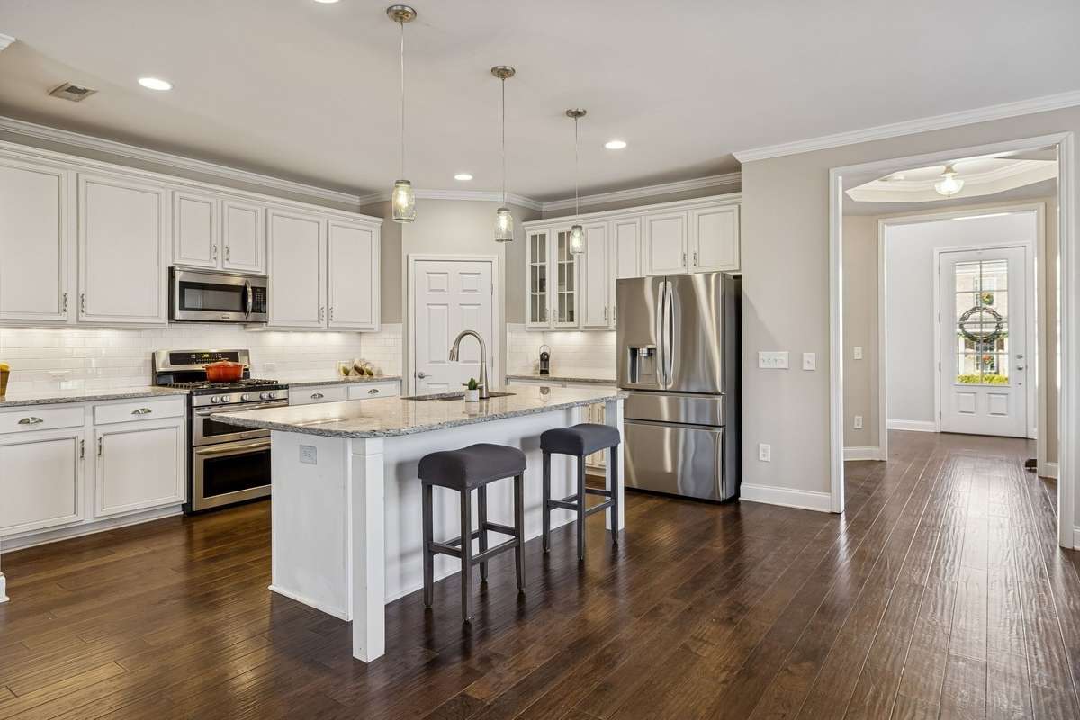 Well-appointed kitchen featuring granite countertops and ample cabinetry. This home features an open floor plan, ideal for gatherings and entertainment.