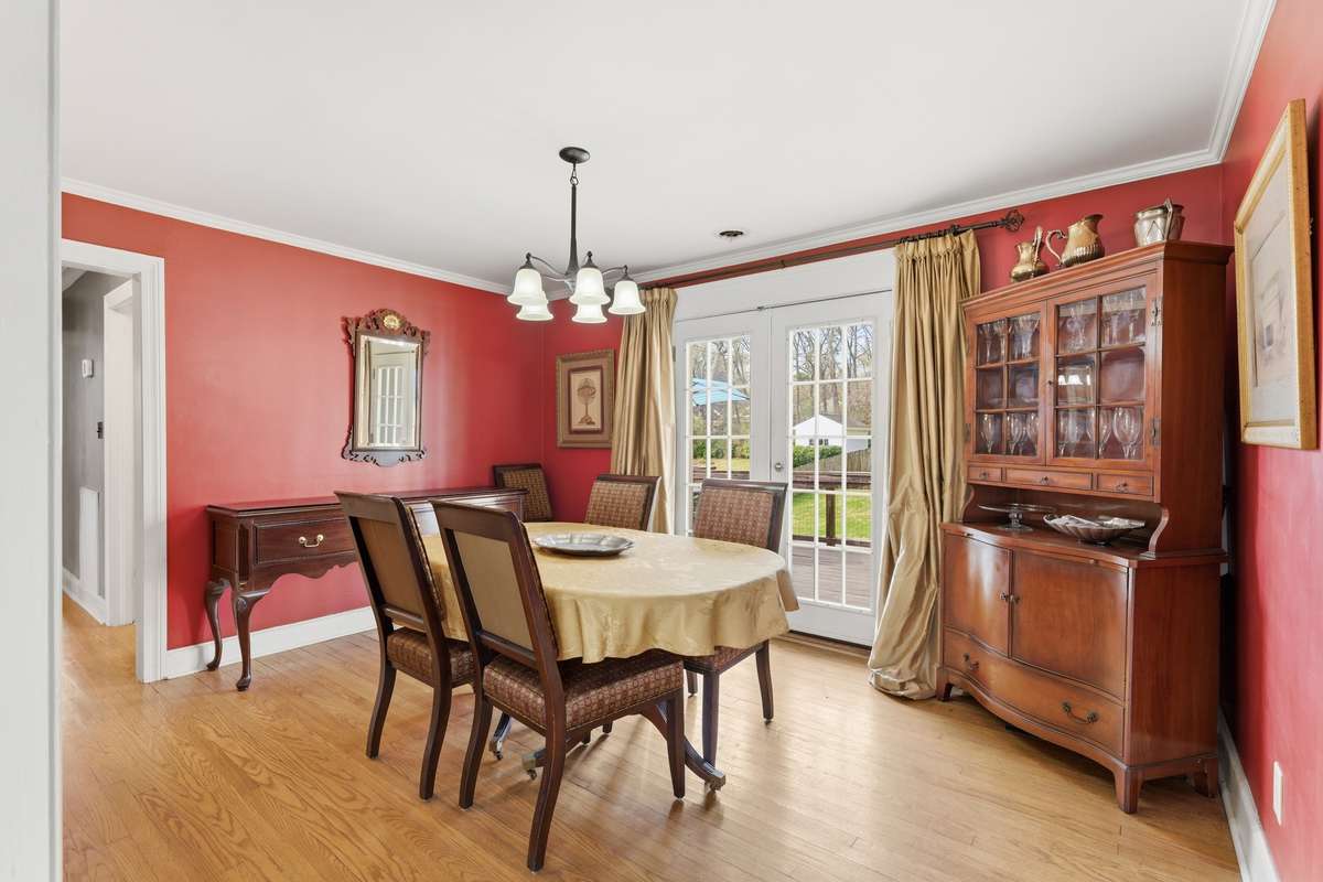 Formal dining room with french doors opening up to the back deck