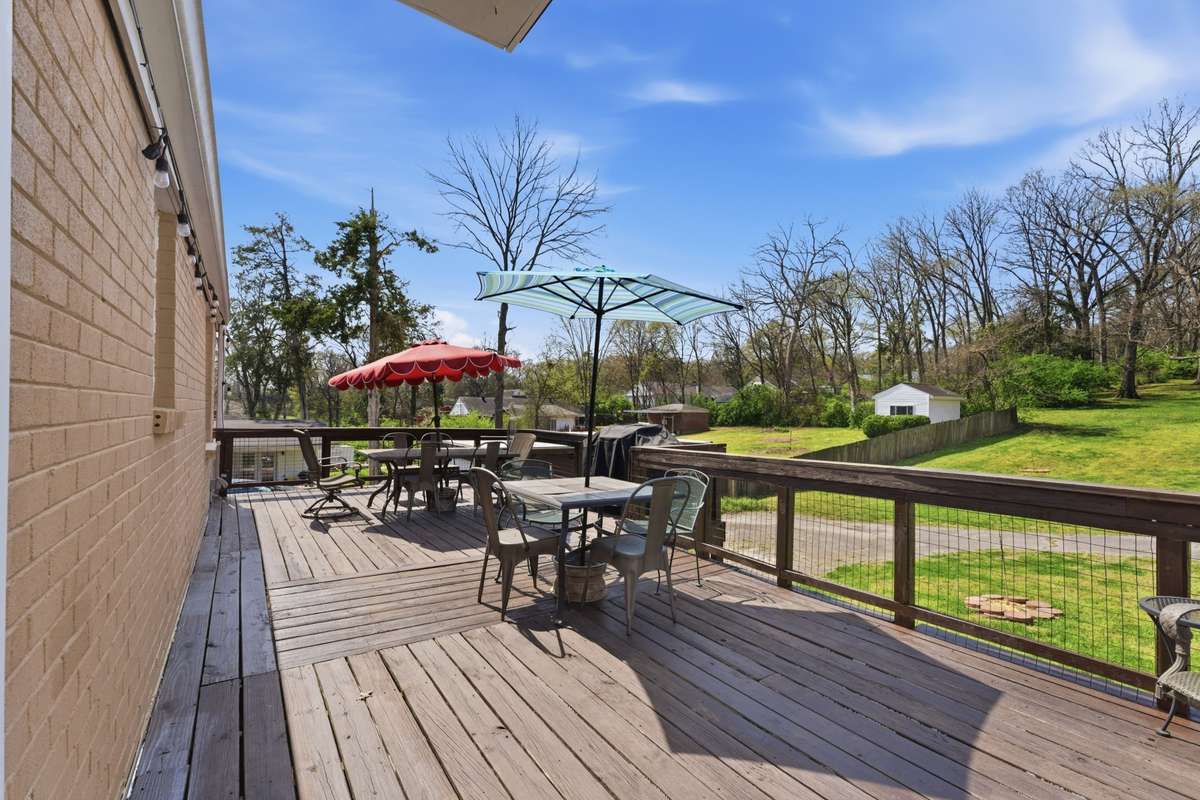 Freshly stained deck makes a great place to gather to overlook the spacious backyard!