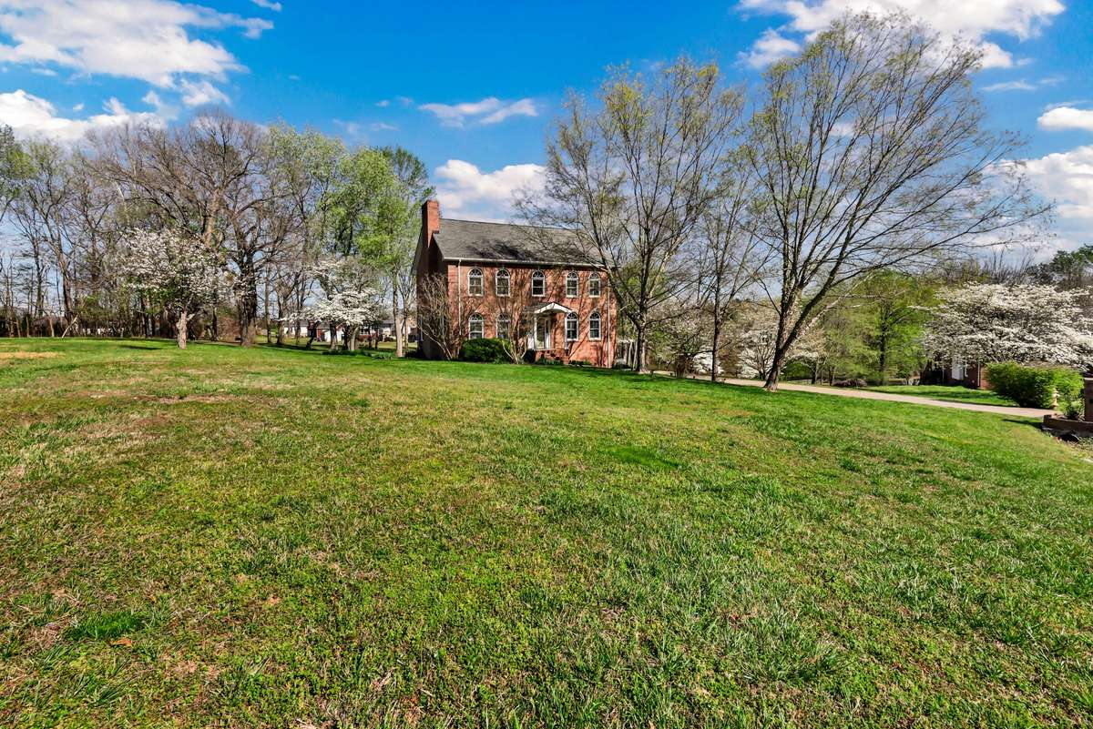 Beautifully set on a sprawling, tree-lined 1.68-acre lot