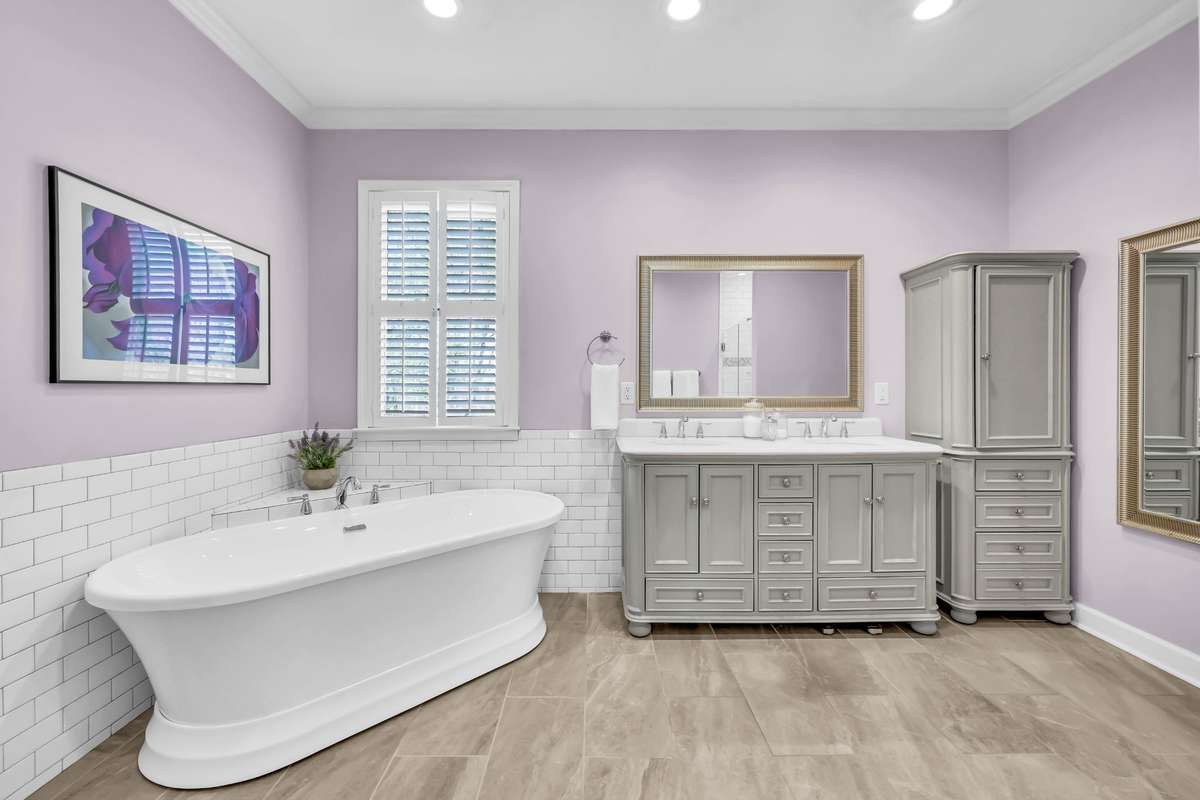 The primary bathroom is bright + spacious
