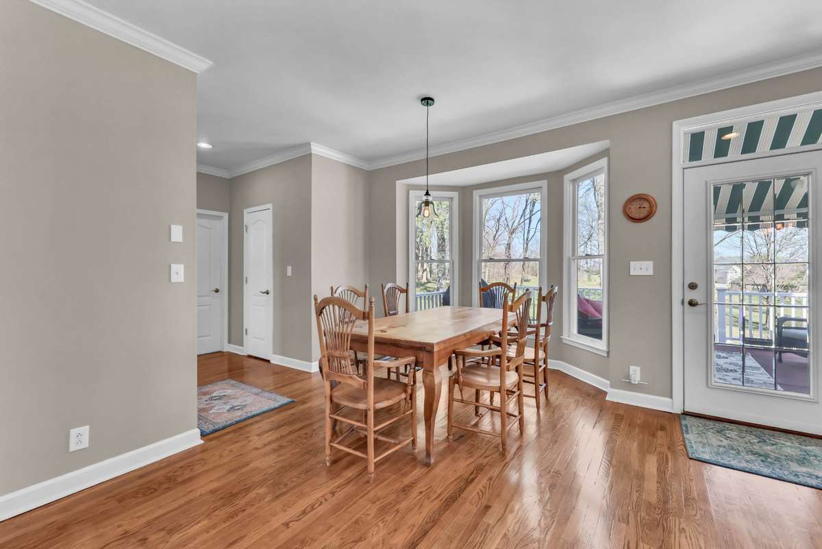 The eat-in area in the kitchen features updated lighting & all the views.