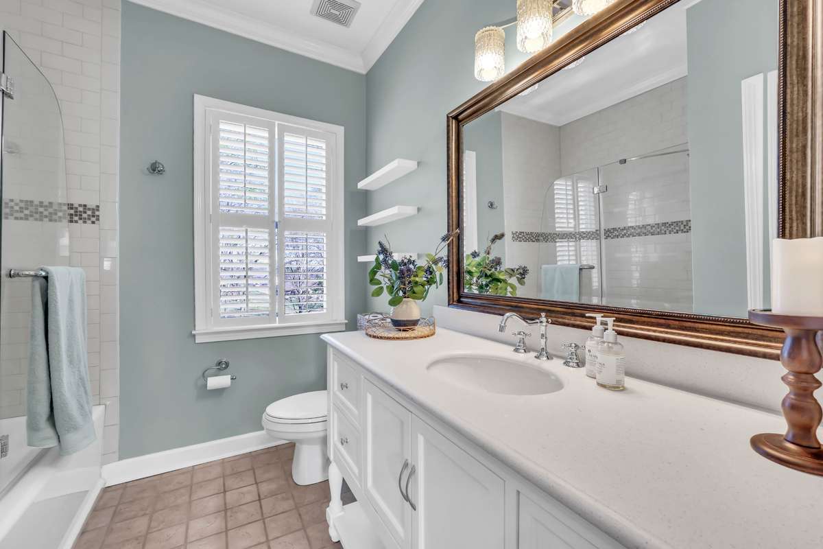 The guest bathroom has also been completely renovated with a spacious vanity with quartz counters + lighting + glass shower door