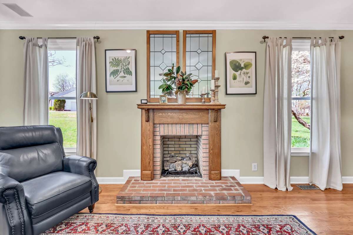 The gas fireplace with brick surround & gorgeous wooden mantle.