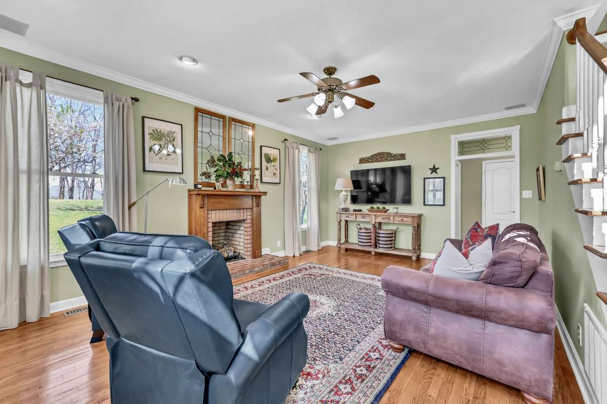 Spacious living room with hardwood + natural light + gas fireplace