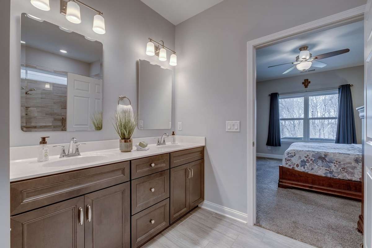 Primary Bathroom with double vanities and upgraded mirrors & lighting