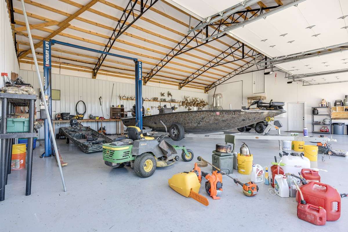 4 garage door workshop with a 10K pound vehicle lift. The shop is 1960 sq. ft. Just to get an idea, that is a 24' boat on the trailer. You won't get that in any standard garage.