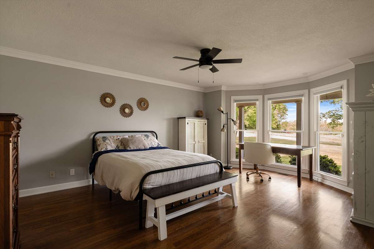 Primary bedroom on main level with large windows