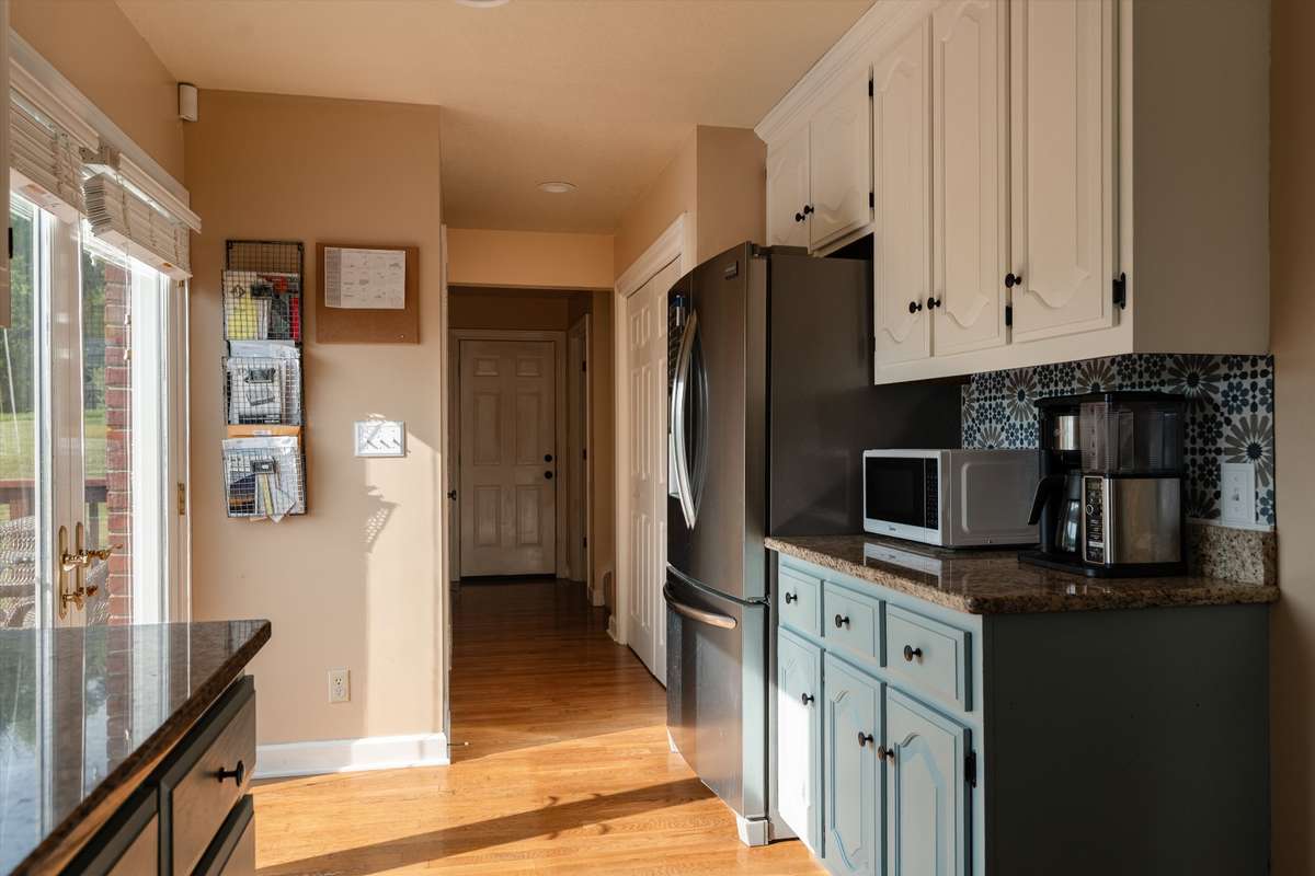 Hallway off kitchen has your half bath, stairs to your bonus room, laundry room and garage
