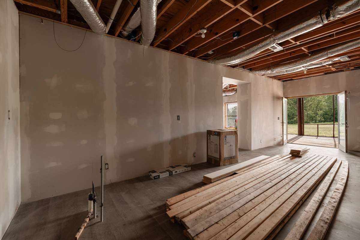 This walkout basement has plumbing for a wet bar or kitchen build out! Double french doors to the back covered porch