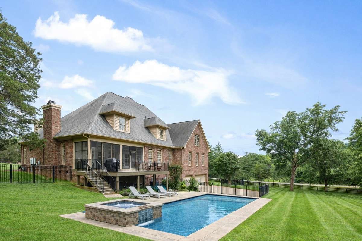 This photos has been virtually enhanced to show what the yard could look with a pool.