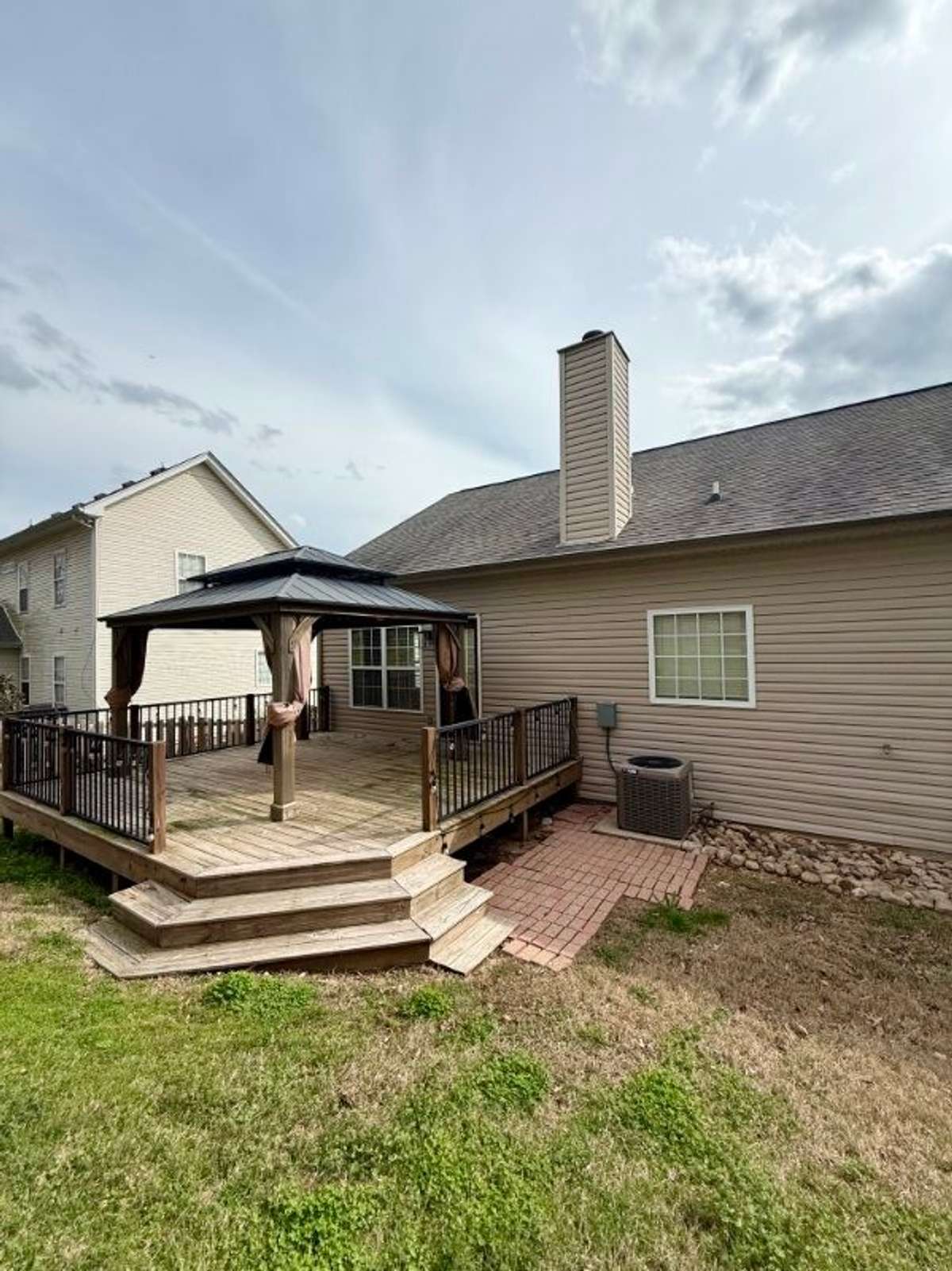 Back of home with deck and gazebo