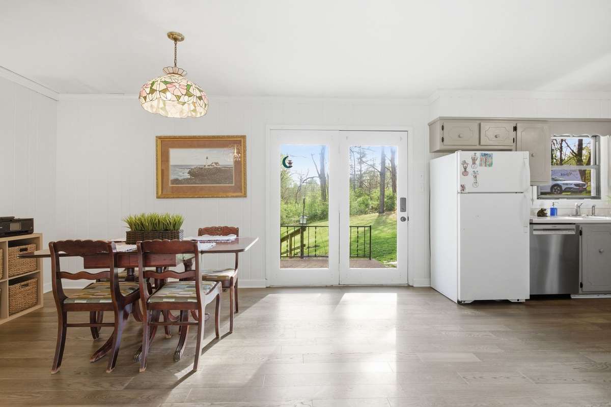 The charming French door with one active panel offers a beautiful view of the back yard and lets in tons of natural light.