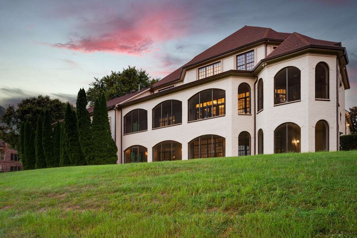 The back of the house is rimmed with double screened wraparound  porches.
