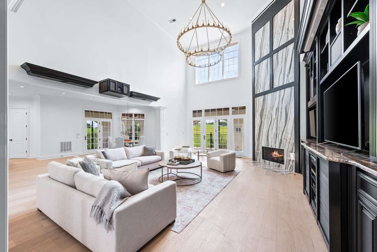 Soaring ceilings, walls of built-ins and tall doors and windows are hallmarks of the living space.