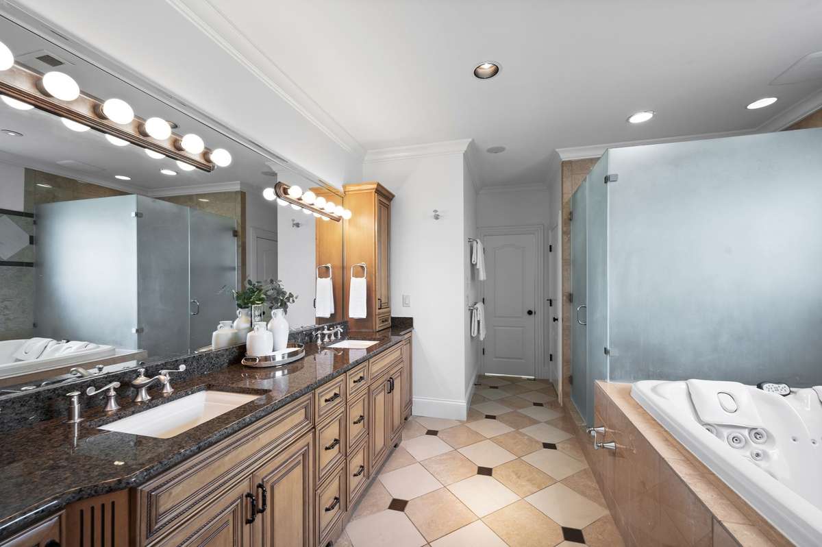 Primary bath has double vanities and a huge shower.