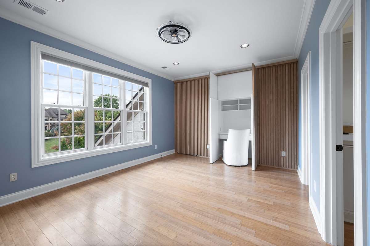 One of three upstairs bedrooms.  This one has a hidden desk/make up table in the wall.  The other doors are also hidden and one goes to the closet and one to the immense attic.