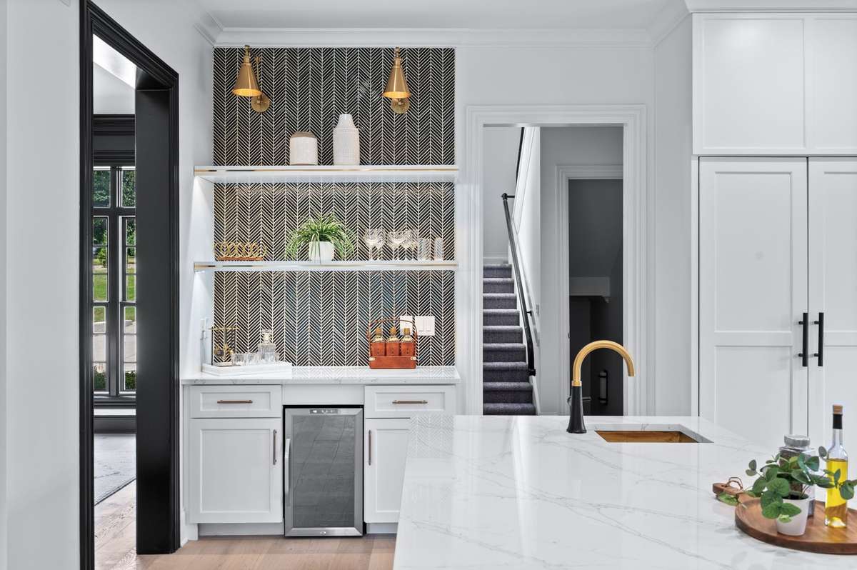 This is such a designer touch.  Coffee/Wine bar has custom chevron tile and a built-in wine cooler.  Note the cool lighting!