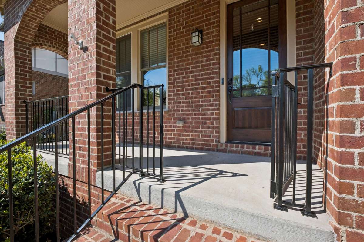 A spacious front porch with plenty of room for a rocking chair or two, plus a gate!