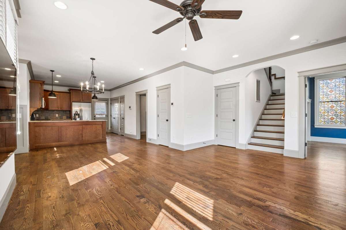 The first floor features a dedicated office, living space, kitchen and dining area, primary bedroom/bathroom and a half bath.