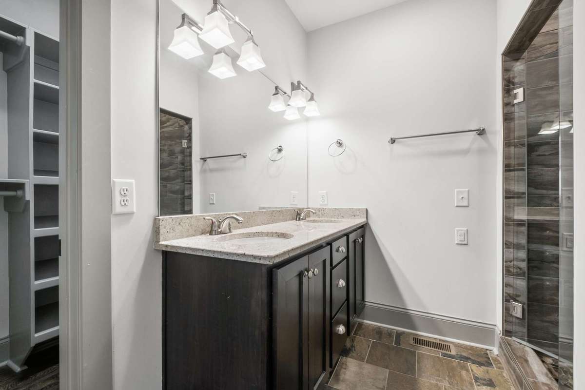 Primary bath features a walk in shower, double vanities and access to a generously sized primary closet.
