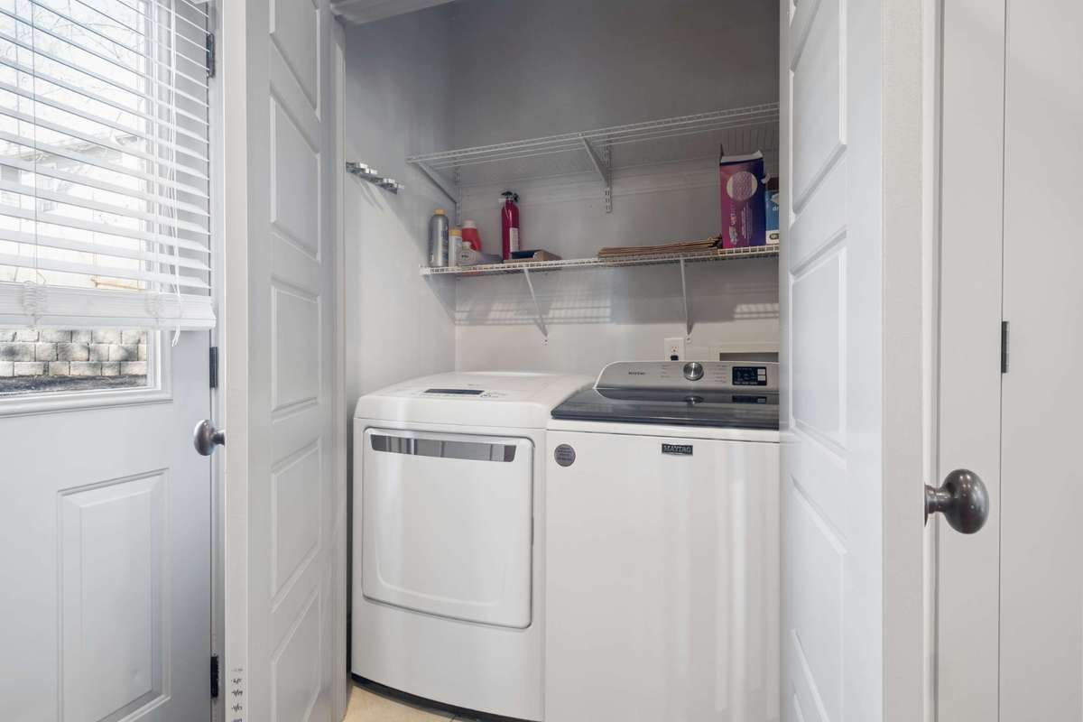 Laundry room is located just off of the kitchen.