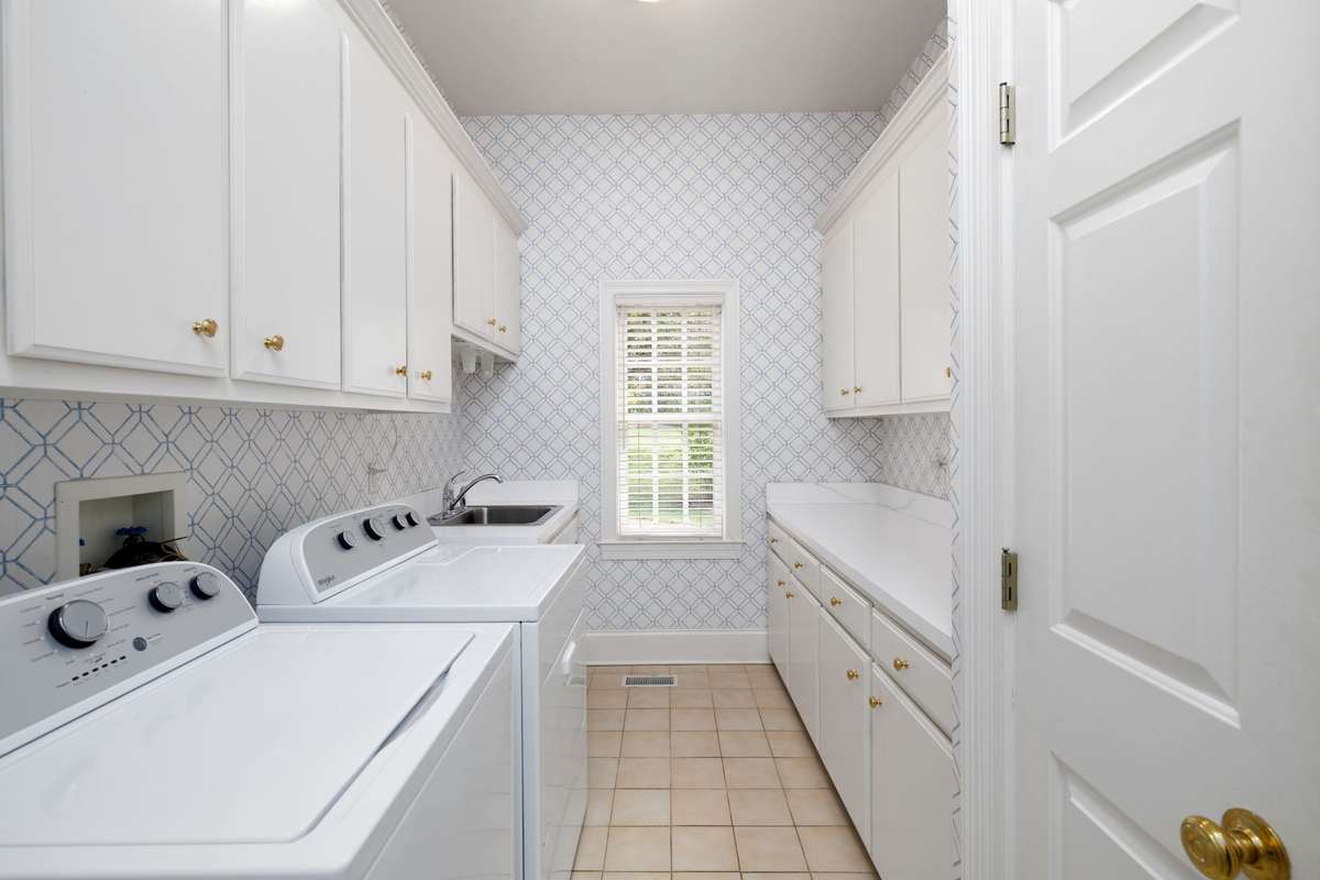 Laundry area with sink conveniently located near kitchen
