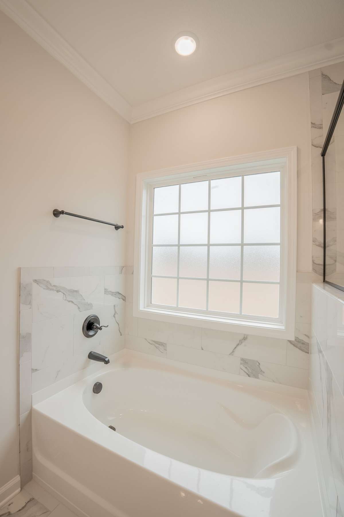 Soaker Tub with a Frosted Window and Tile Surrounding! Perfect to Relax in After a Long Day!