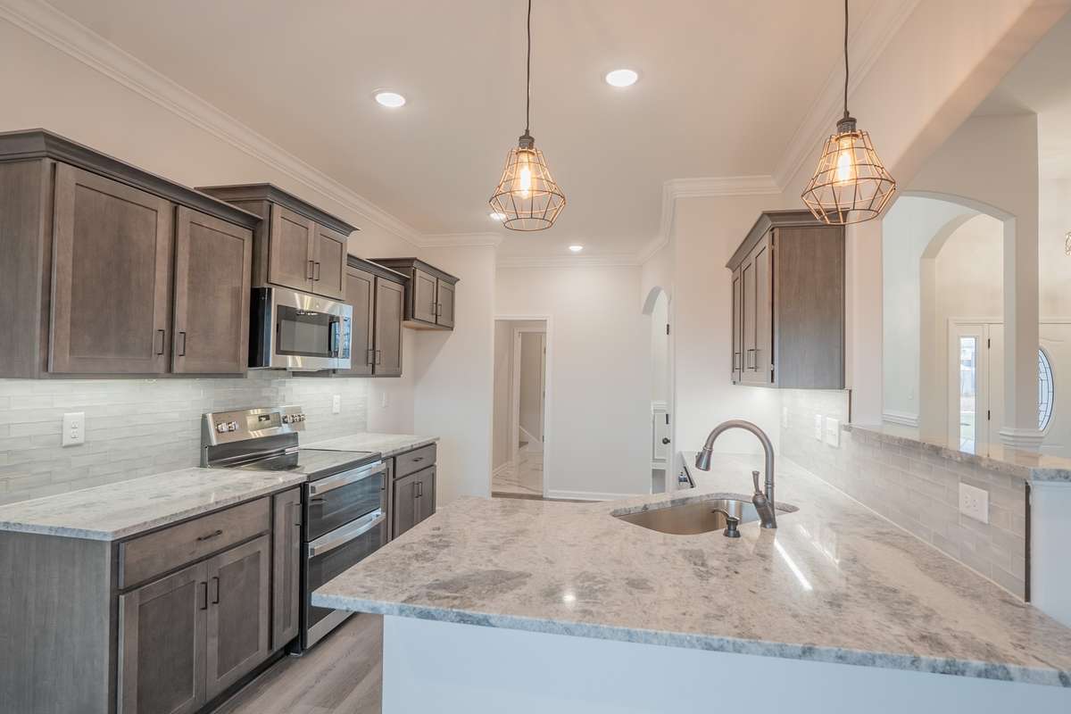 Large Kitchen with a Double Oven Range, Peninsula Bar, Serving Bar, Granite Countertops, Tile Backsplash, Recessed Lighting and Lots of Cabinetry - All with Soft Close Doors and Drawers!!