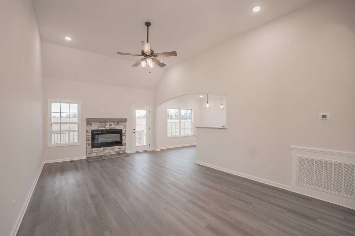 Large Living Room with a Stone Fireplace, Floating Wood Mantle, Crown Molding and Access to the Large Covered Deck!